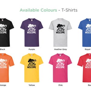 May include: A selection of t-shirts in various colors, each featuring a black and white illustration of a cat with the text "You're Welcome". The colors include black, purple, heather grey, royal blue, orange, yellow, pink, and red.
