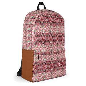 May include: A backpack with a repeating geometric pattern in shades of pink, red, and green. The backpack has a brown pocket on the side and a black zipper. The top handle and straps are black.