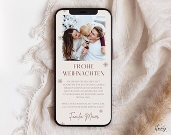 May include: A white smartphone with a Christmas card design. The card features a photo of a family with a child, snowflakes, and the text "Frohe Weihnachten" in a brown font. The text below the photo reads "In dieser festlichen Zeit möchten wir euch von ganzem Herzen besinnliche Momente, glückliche Augenblicke und unvergessliche Erinnerungen wünschen. Moge eure Weihnacht von Liebe, Lachen und Wärme erfüllt sein. Familie Meier."