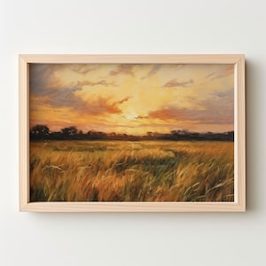 Peut inclure: Une peinture à l'huile encadrée représentant un champ de hautes herbes avec un coucher de soleil en arrière-plan. Le ciel est un mélange d'orange, de jaune et de rose avec des nuages. L'herbe est un mélange de vert et de brun.