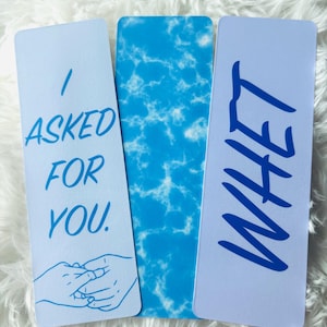 May include: Three blue bookmarks with white text and a blue and white marble pattern. The text on the bookmarks reads "I asked for you", "What", and a blue and white marble pattern.
