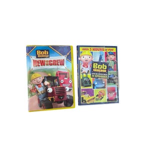 May include: Two Bob the Builder DVDs. The first DVD is titled "New Crew" and features Bob the Builder with a red tractor. The second DVD is titled "Can-Do Crew Pack" and features Bob the Builder and other characters.