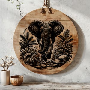 May include: A black and white illustration of an elephant walking through a jungle scene. The elephant is depicted in a realistic style with detailed features. The background features lush foliage and a stream.