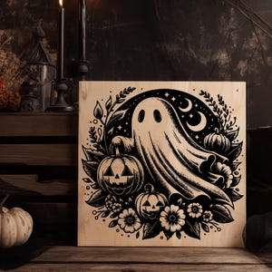 May include: A wooden Halloween-themed sign featuring a black and white illustration of a ghost, pumpkins, flowers, stars, and crescent moons. The artwork is set against a light wood background, creating a rustic and spooky aesthetic.