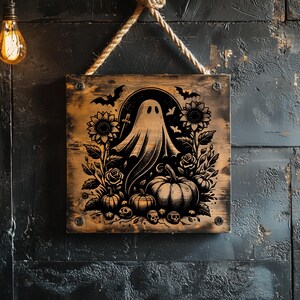 May include: Wooden Halloween sign featuring a black and white illustration of a ghost, pumpkins, sunflowers, roses, bats, and skulls. The sign is square and hangs from a rope.