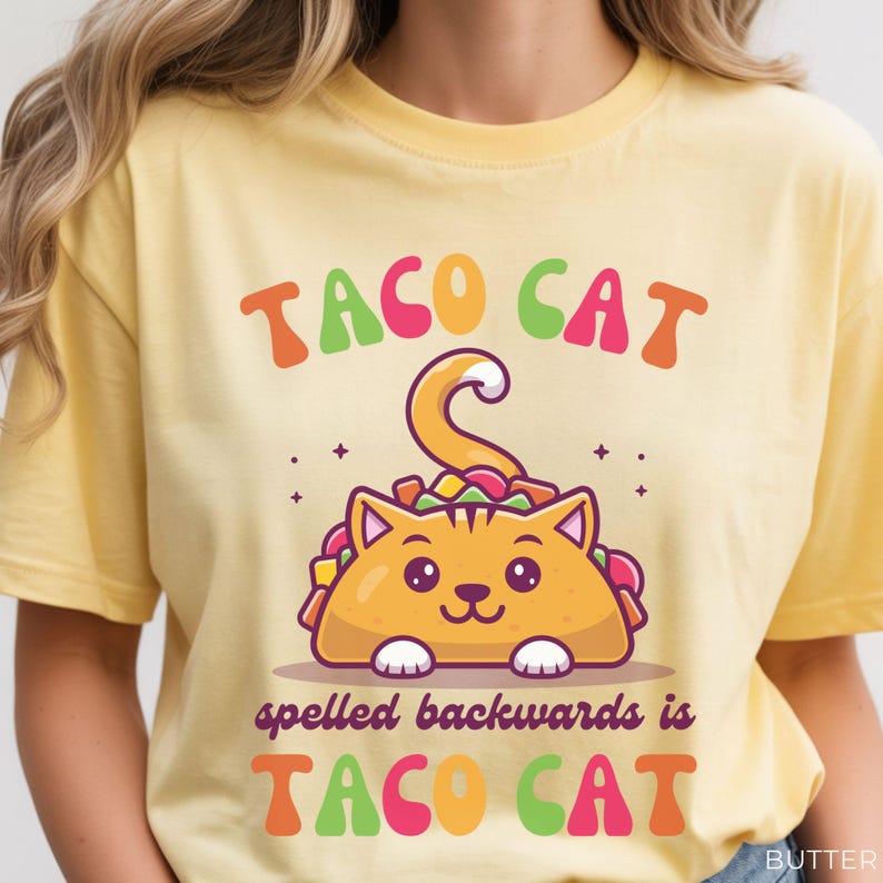 Cute taco cat shirt displayed on butter yellow Comfort Colors tee featuring colorful palindrome phrase and adorable taco cat graphic for cat lovers and quirky humor fans.