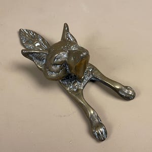 May include: A set of three ceramic mugs with a speckled, matte finish in cream, light grey, and dark grey. Each mug has a simple, minimalist design and a rounded handle.