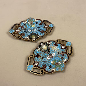 May include: Two ornate, decorative, brass, enamel, floral,  trays with blue, white, black, and gold accents.