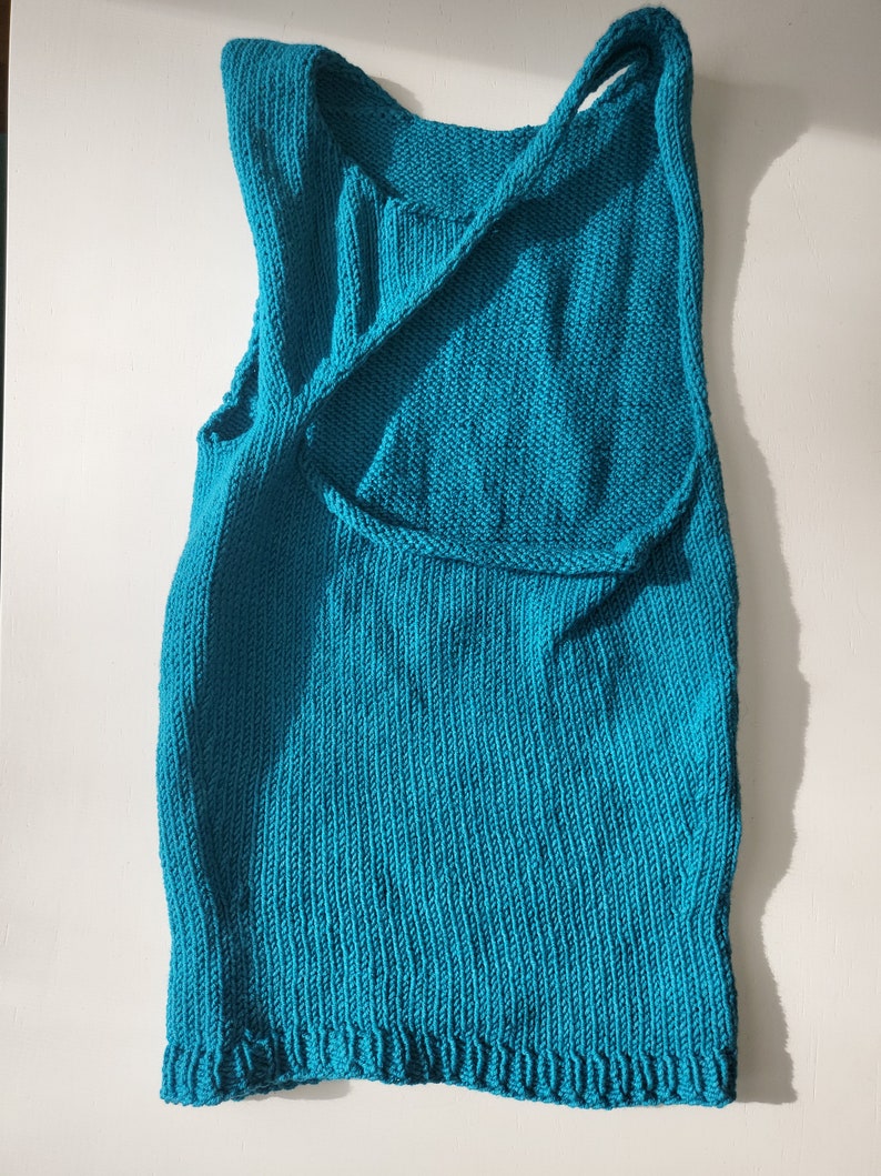 Teal, asymmetrical crop top displayed against white background