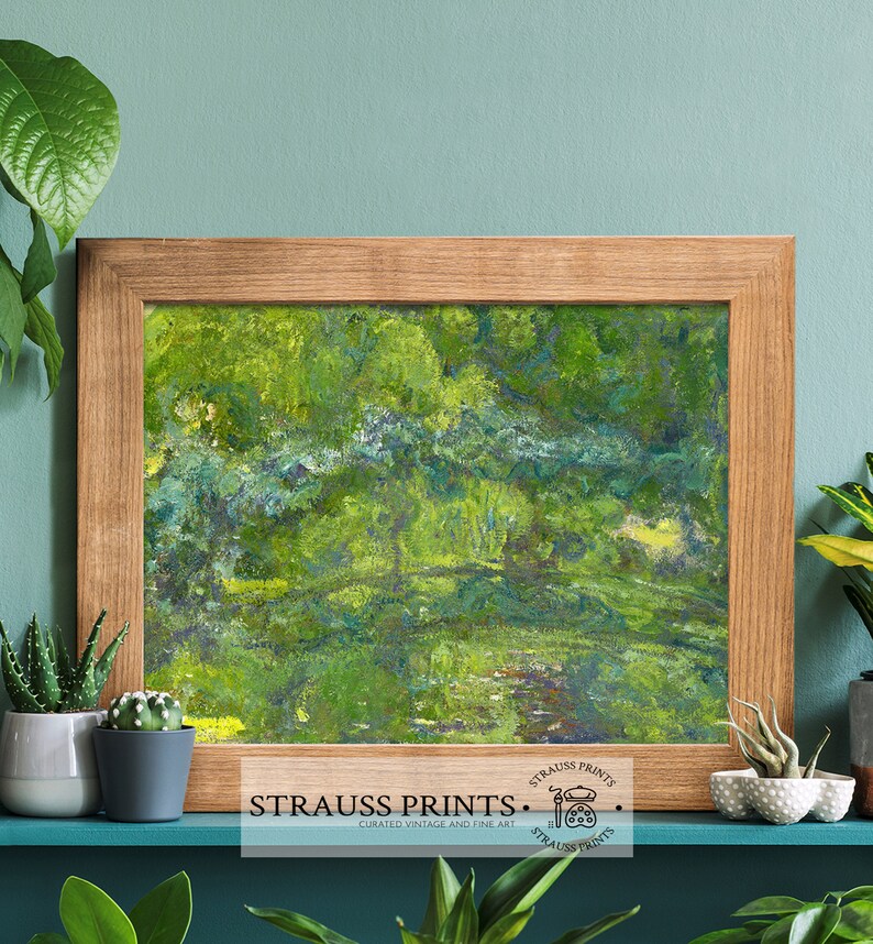 May include: A framed abstract painting of a green landscape with a light blue sky. The painting is in a wooden frame and is hanging on a teal wall. The painting is titled "Strauss Prints" and has a logo with a paintbrush and palette.