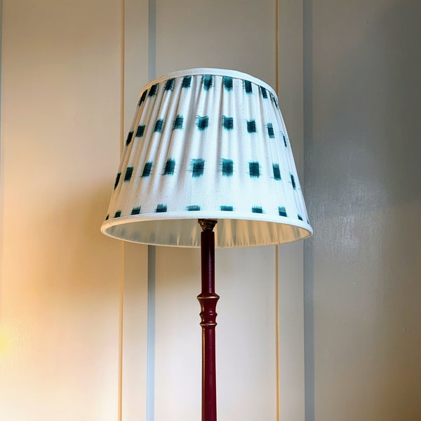 A 12” hand-sewn pleated French drum ikat lampshade made with green & cream ikat cotton