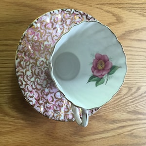 Gladstone cup and saucer with single pink flower.