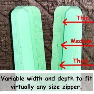 May include: A mint green V-shaped zipper pull replacement tool with three distinct notched sections labeled with red arrows as Thin, Medium, and Thick. The text at the bottom reads: Variable width and depth to fit virtually any size zipper.