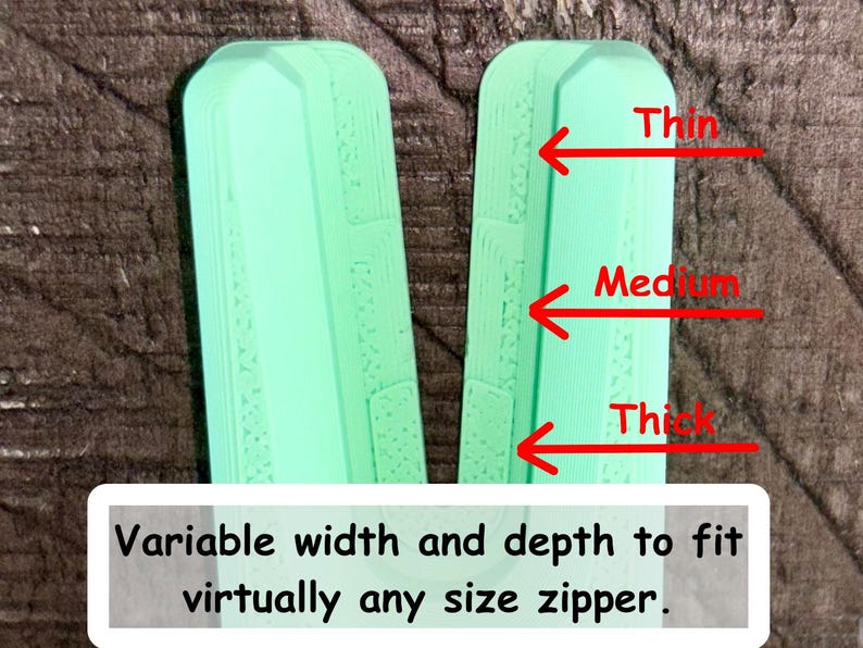May include: A mint green V-shaped zipper pull replacement tool with three distinct notched sections labeled with red arrows as Thin, Medium, and Thick. The text at the bottom reads: Variable width and depth to fit virtually any size zipper.