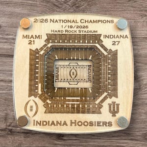 May include: Wooden plaque commemorating the 2026 National Champions game at Hard Rock Stadium. Features a detailed stadium layout, scores for Miami and Indiana, and the text "INDIANA HOOSIERS". Includes four metallic magnets.