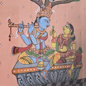 May include: Colorful Indian artwork depicting two figures under a tree. One figure plays a flute, the other holds a leaf. The figures are on a decorative platform above a water scene with swans and flowers. The background is peach.