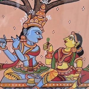 May include: Colorful Indian folk art painting depicting two figures under a tree. The figures are adorned in traditional clothing and jewelry. The background is a soft peach color, and the bottom of the painting shows a pond with swans and lotus flowers.