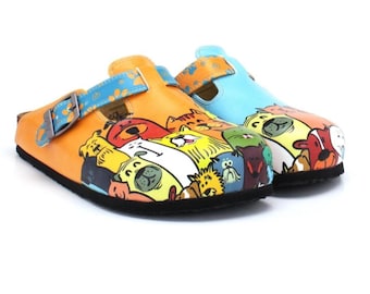 May include: A pair of slip-on clogs featuring a vibrant, multi-colored cartoon illustration of various dog breeds across the front. The left clog is orange with a blue strap, while the right clog is light blue with an orange strap and metal buckles.
