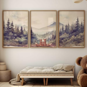 May include: Three watercolour paintings of a woodland scene with a mountain range in the background. The paintings are framed in wood and hung on a white wall. A brown teddy bear sits on a light brown bench in front of the paintings.