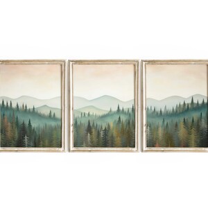 May include: A set of three framed prints depicting a misty forest scene with a row of evergreen trees in the foreground and a hazy mountain range in the background.