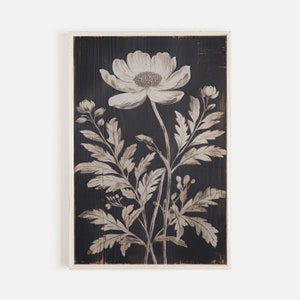 May include: A black and white floral print on a wood panel. The print features a large flower with delicate leaves and stems.