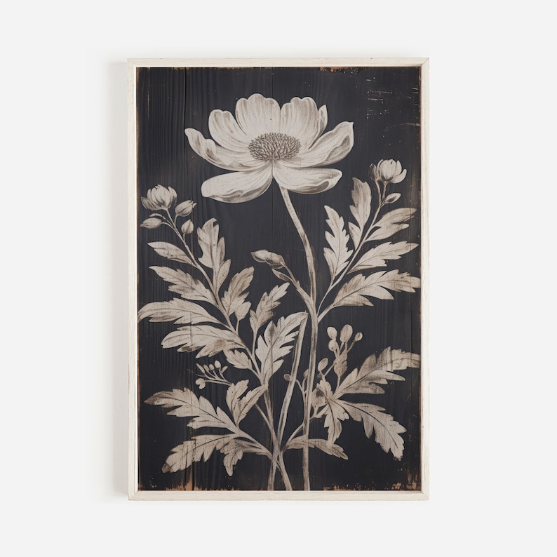 May include: A black and white floral print on a wood panel. The print features a large flower with delicate leaves and stems.
