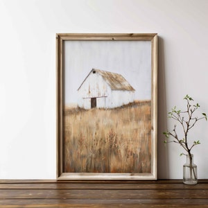 May include: A framed painting of a white barn in a field of tall grass. The barn has a rusty metal roof and a single wooden door. The grass is a mix of brown and yellow.