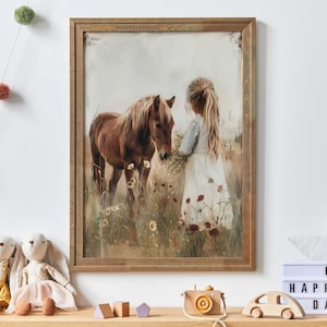 Puede incluir: Una pintura enmarcada de una niña con un vestido blanco alimentando a un caballo marrón en un campo de flores silvestres.