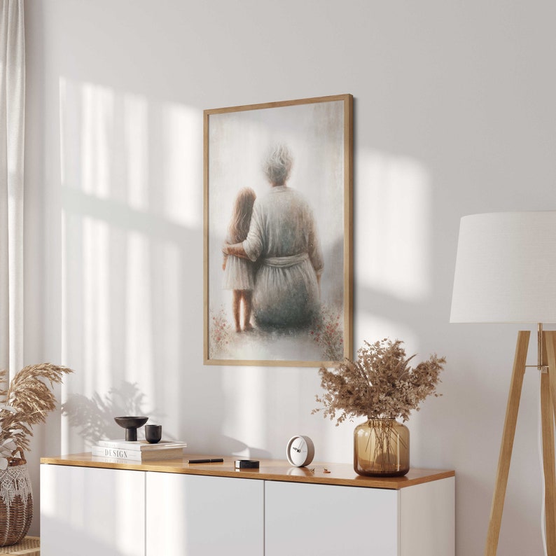 May include: A framed painting of an older woman and a young girl standing side by side. The woman is wearing a long, white robe and the girl is wearing a dress. They are both looking away from the viewer. The painting is set against a light background.