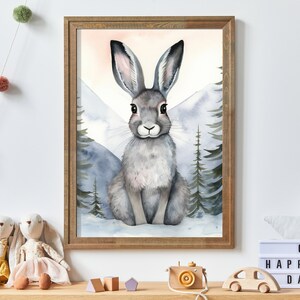 May include: A watercolor painting of a gray rabbit sitting in a snowy mountain landscape. The rabbit has large ears and is looking directly at the viewer. The background is a soft blue and gray with white snow.