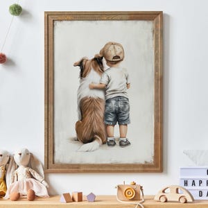 May include: A framed illustration of a boy wearing a baseball cap and a dog. The boy is hugging the dog from behind. The dog is a brown and white border collie. The illustration is on a white background with a light brown frame.