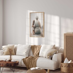 May include: A framed watercolor painting of an older woman and a young girl sitting together. The woman has gray hair and is wearing a long, flowing dress. The girl has long brown hair and is wearing a white dress. The painting is set against a soft, muted background.