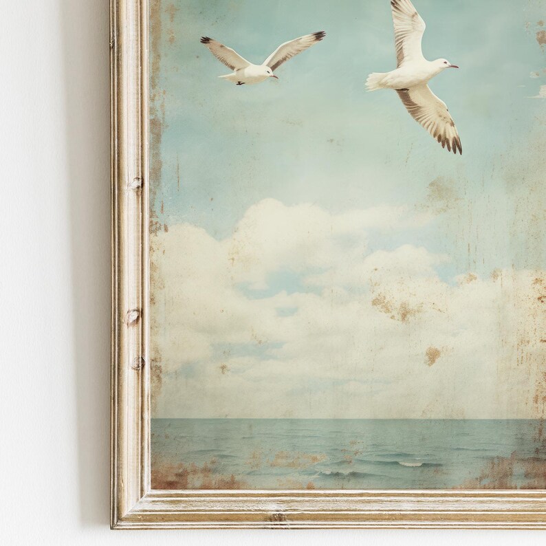 Puede incluir: Una impresi&oacute;n vintage enmarcada de dos gaviotas blancas volando sobre un oc&eacute;ano azul con nubes blancas en el cielo.