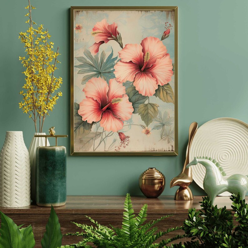 May include: A framed vintage botanical print featuring pink hibiscus flowers with green leaves on a light blue background.