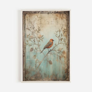 K&ouml;nnte beinhalten: Ein Vintage-Rahmenbild mit einem kleinen orangefarbenen und grauen Vogel, der auf einem Zweig mit wei&szlig;en Bl&uuml;ten sitzt. Der Hintergrund ist ein verblasster blauer und gr&uuml;ner Aquarell-Wasch mit einer abgenutzten Textur.
