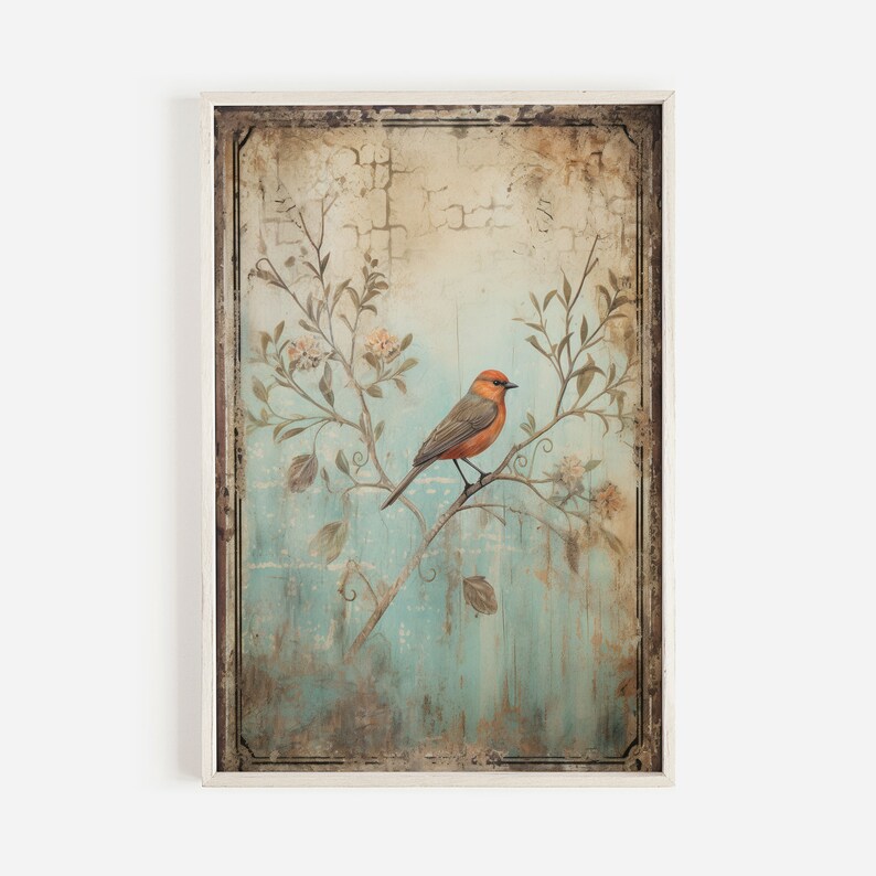 K&ouml;nnte beinhalten: Ein Vintage-Rahmenbild mit einem kleinen orangefarbenen und grauen Vogel, der auf einem Zweig mit wei&szlig;en Bl&uuml;ten sitzt. Der Hintergrund ist ein verblasster blauer und gr&uuml;ner Aquarell-Wasch mit einer abgenutzten Textur.