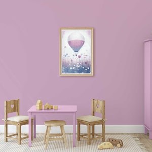 May include: A light purple playroom with a wooden table and chairs, a pink cabinet, and a framed print of a hot air balloon flying over a field of flowers.