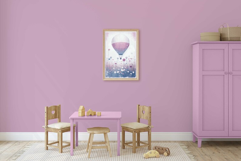 May include: A light purple playroom with a wooden table and chairs, a pink cabinet, and a framed print of a hot air balloon flying over a field of flowers.