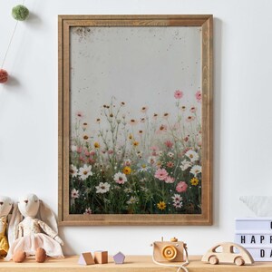 May include: A framed print of a watercolor painting featuring a field of pink, white, and yellow wildflowers. The flowers are arranged in a vertical row, with the tallest flowers at the top of the image. The background is a soft, muted gray.