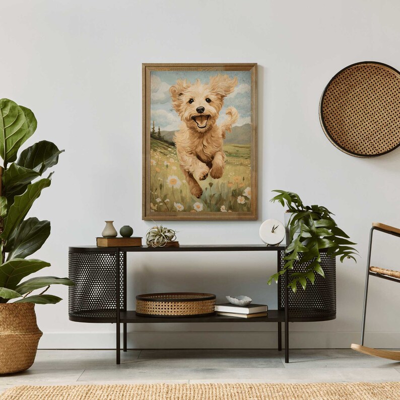 May include: A framed painting of a golden retriever puppy running through a field of wildflowers. The puppy is smiling and has its tongue sticking out. The background is a green field with a blue sky and white clouds.