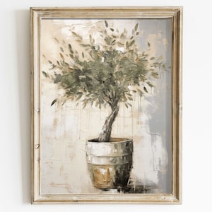Op de afbeelding: Een ingelijst schilderij van een groene olijfboom in een bruine pot tegen een lichtbeige en grijze achtergrond.