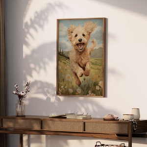 May include: A framed painting of a golden retriever puppy running through a field of wildflowers. The puppy is smiling and has its tongue sticking out. The background is a green field with blue sky and white clouds.