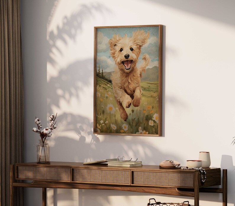 May include: A framed painting of a golden retriever puppy running through a field of wildflowers. The puppy is smiling and has its tongue sticking out. The background is a green field with blue sky and white clouds.