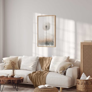 May include: A white sofa with brown throws and cushions in a living room featuring a wooden cabinet, a wooden coffee table, and a framed print of a dandelion.