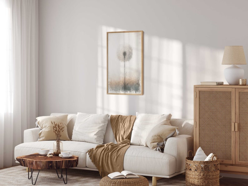 May include: A white sofa with brown throws and cushions in a living room featuring a wooden cabinet, a wooden coffee table, and a framed print of a dandelion.