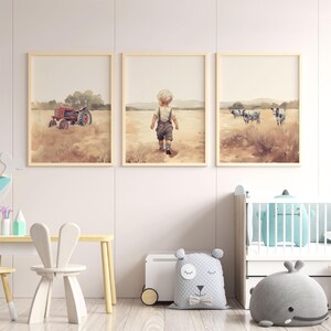 May include: Three watercolour paintings in wooden frames depicting a red tractor in a field, a young boy walking in a field, and three cows in a field.