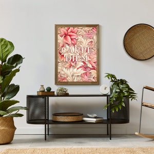 May include: A framed print with a floral design in shades of pink and cream. The print features the Latin phrase "Carpe Diem" in a decorative font.