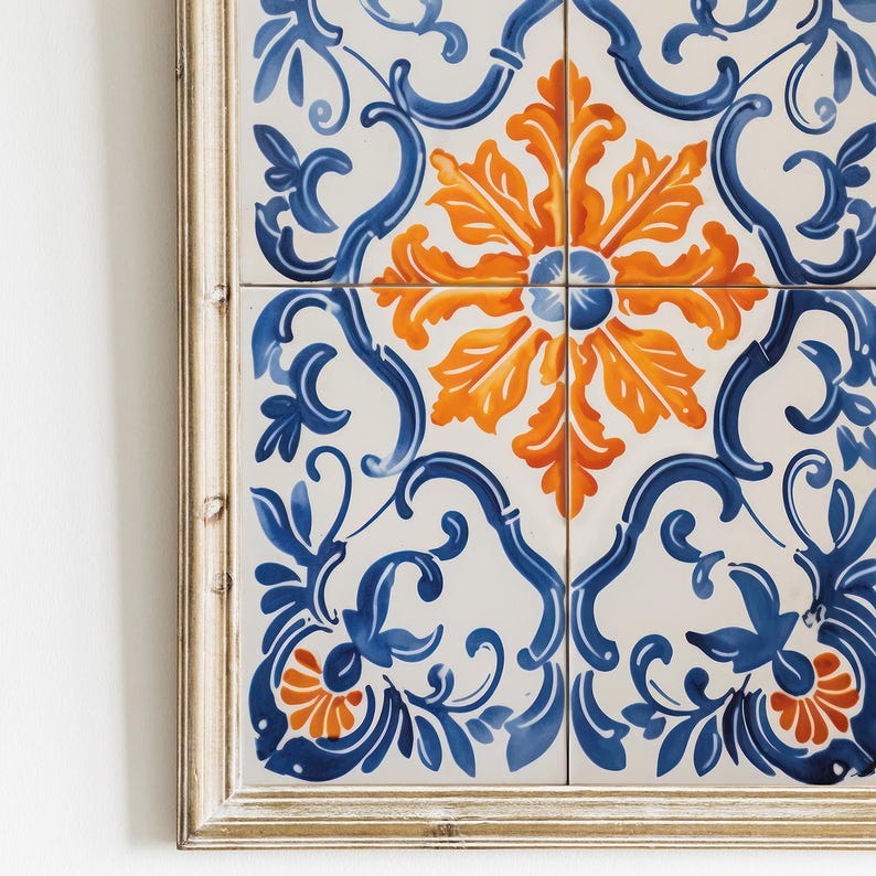 May include: A framed wall art piece featuring a blue and orange floral pattern on white tiles. The tiles are arranged in a square pattern, with a central flower motif.