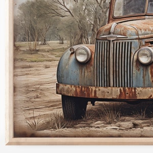 May include: A vintage blue and rusty truck parked in a dirt field with trees in the background.