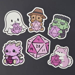May include: A collection of whimsical stickers featuring cartoon characters, including a ghost, scarecrow, Frankenstein's monster, dragon, and a fox, each holding a pink twenty-sided die. The stickers are on a black background.